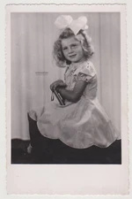Cute Little Girl with Big Bow and Smile Ready to Charm the Camera Forever Photo