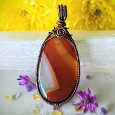 Red banded agate teardrop cabochon wrapped in...
