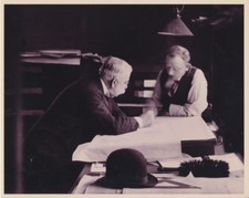 REPRODUCTION OF ORIGINAL PHOTO OF MEN LOOKING OVER BLUEPRINTS