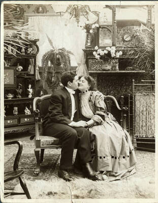 Seen A Couple Sitting In A Loveseat, And The Man Is Kissing The Woma - Old Photo