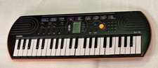 Casio SA-76 Electronic Mini Keyboard, orange, black color 100 Tones. Drums