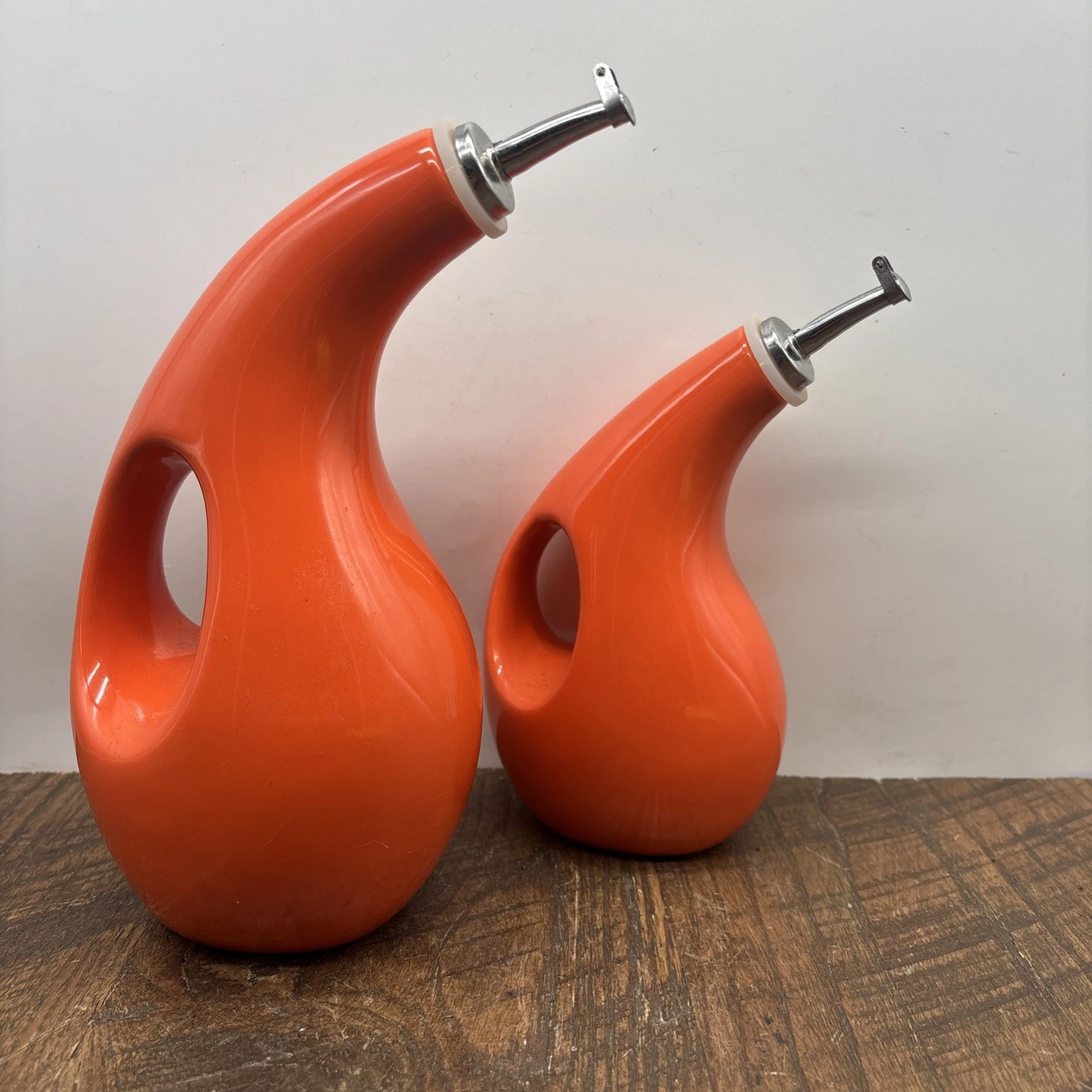 Rachel Ray oil and vinegar dispensers ceramic orange 2 different sizes