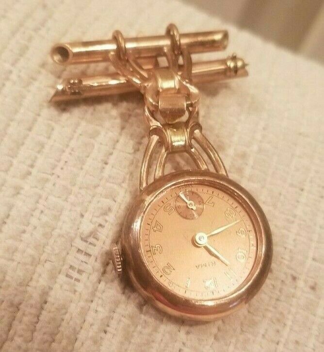 VINTAGE RIMA COPPER LAPEL WATCH - STARTS AND STOPS - WATCH GLASS MISSING