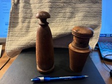 These are antique wooden kitchen tools, likely a primitive spice or pepper grind