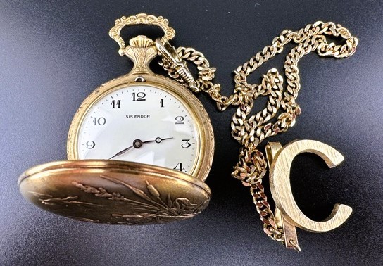 A gold-tone hunting pocket watch engraved with a hunting dog and duck scene, personalized with initial 'C' — a ready-made heirloom.
