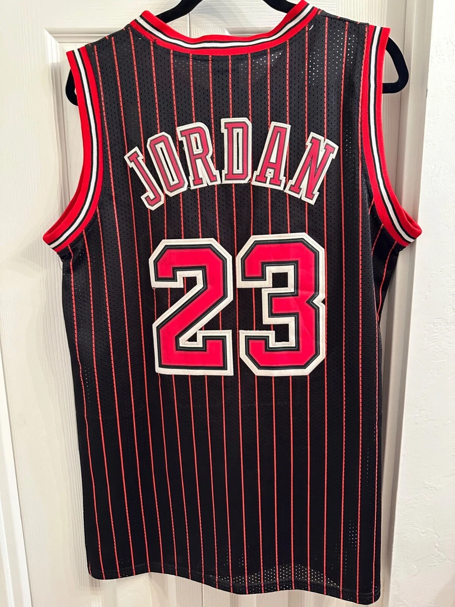 Michael Jordan in the black uniform with red pinstripes introduced