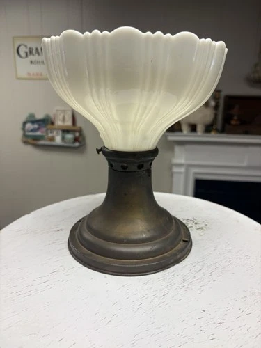 Vintage brass oil lamp with a scalloped milk glass shade.
