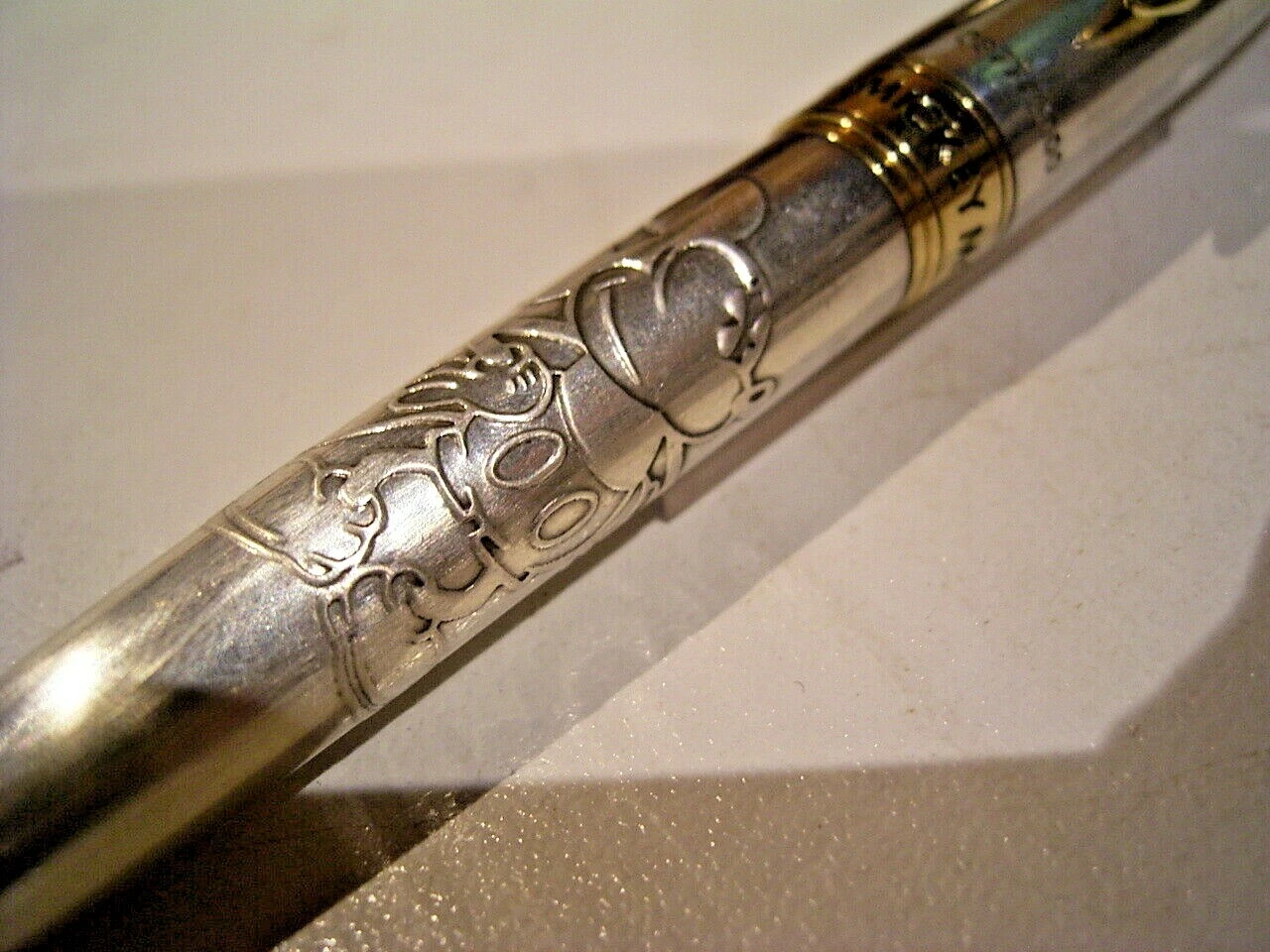 Sterling silver pen with gold accents, featuring embossed Mickey Mouse design and “PILOT” text on barrel.