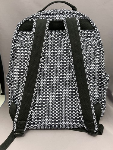 Black and white geometric print monkey keychain from Japan on pink quilted backpack with silver zippers and straps.