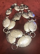 vintage concho belt features embossed oval links, with Navajo designs.