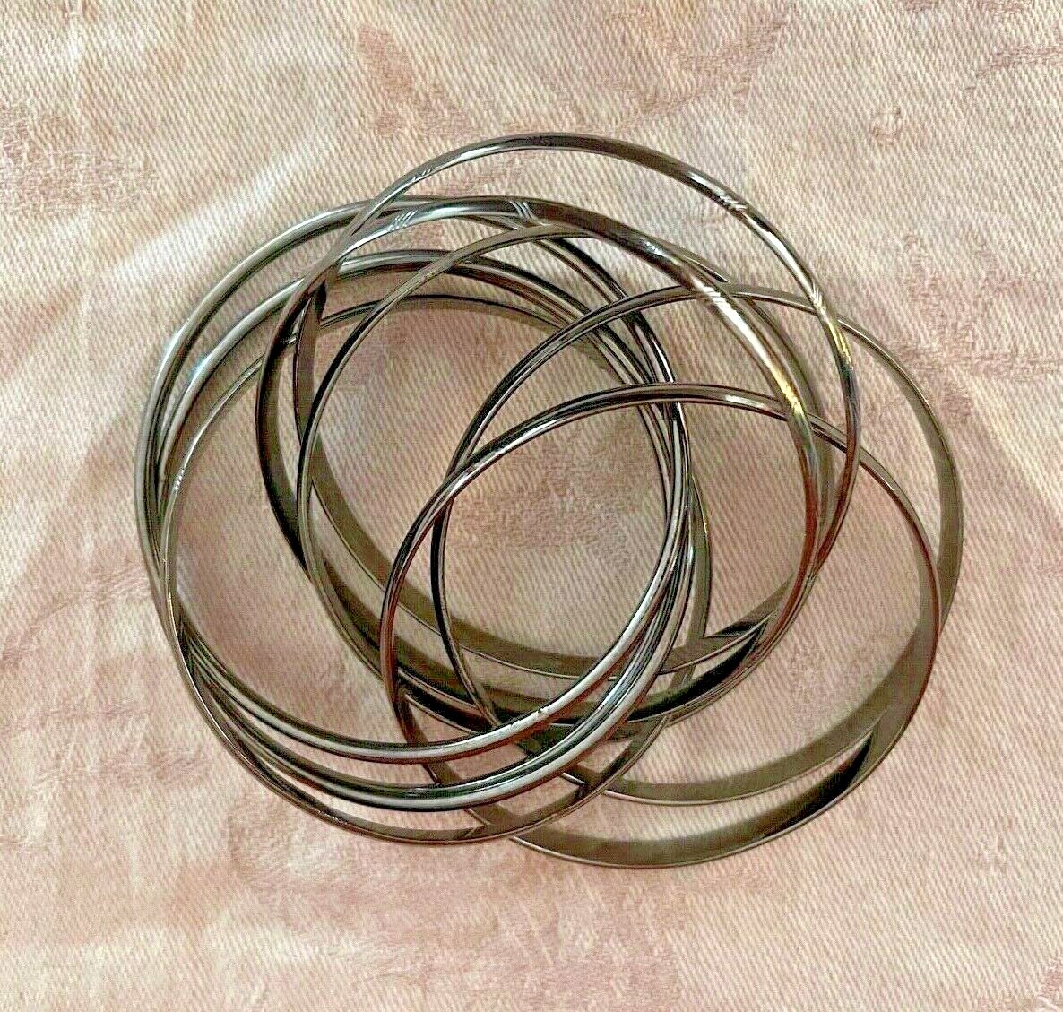Nine Interlocking Dark Gray Metal Bangle Bracelets - image 1