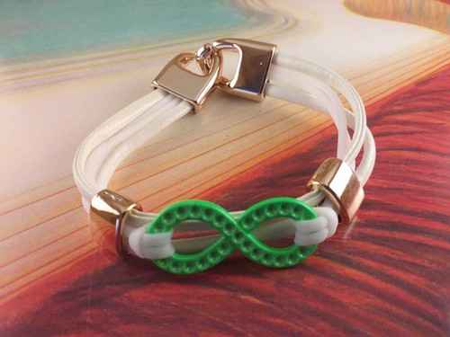 Bracciale Braccialetto Simil Pelle Bianco Simbolo Infinito Verde e Color Oro - Bild 1 von 1