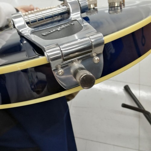 Silver hollow body electric guitar with chrome hardware and three-piece pickguard, viewed from the side.