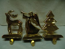 VINTAGE 3 PIECE STOCKING HOLDERS HEAVY CAST GOLD IN COLOR ANGEL/DEER/TREE