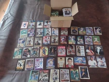 Box of basketball and baseball cards containing many different brands and years.