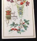 1915 EMBOSSED CHRISTMAS GREETING POSTCARD, SANTA CLAUS, TOYS, FLOWERS, HOLLY — photo 3