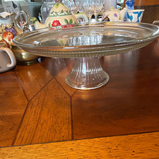 Vintage clear pressed glass pedestal cake stand with radial ribbing.