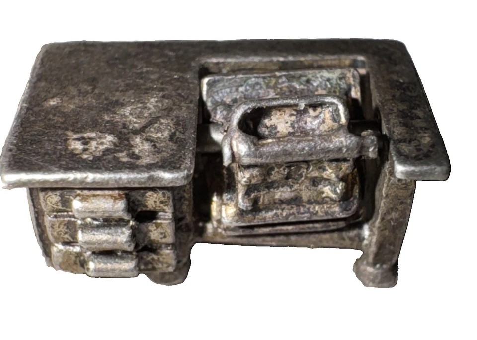 A tiny sterling silver typewriter that actually has movable, articulated parts — wearable vintage charm that doubles as a desk conversation piece.