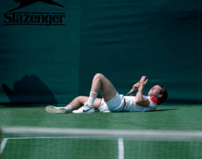 John McEnroe of the USA after falling during the Stella Artois Ch - Old Photo