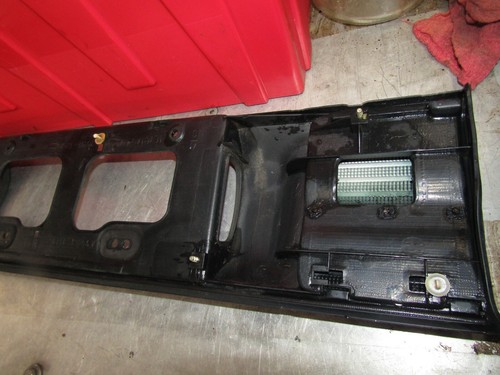 1988-1992 Toyota Corolla sedan OEM trunk trim license plate garnish (broken tab) - Picture 6 of 7