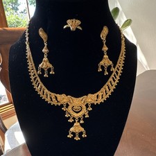22K solid gold jewelry set consisting of matching necklace, earrings and ring.