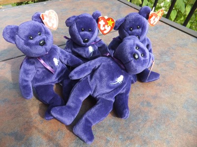purple beanie baby with white flower