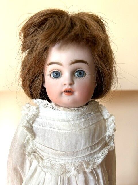 Bisque doll dressed in handmade clothes, 1890-1900