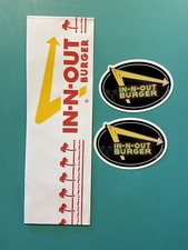 2 IN-N-OUT BURGER STICKERS AND 1 PAPER HAT