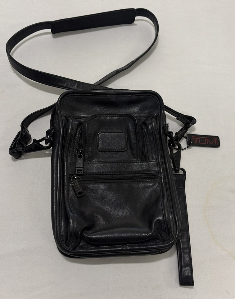 TUMI's bulletproof Alpha line in vintage black leather — a compact crossbody that's basically the gold standard of EDC carry, pre-loved at a steep discount.