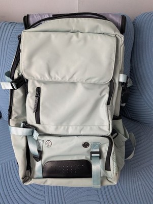 Travel backpack with multiple compartments and carrying options