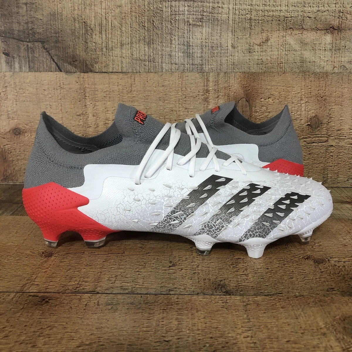 white and red adidas cleats