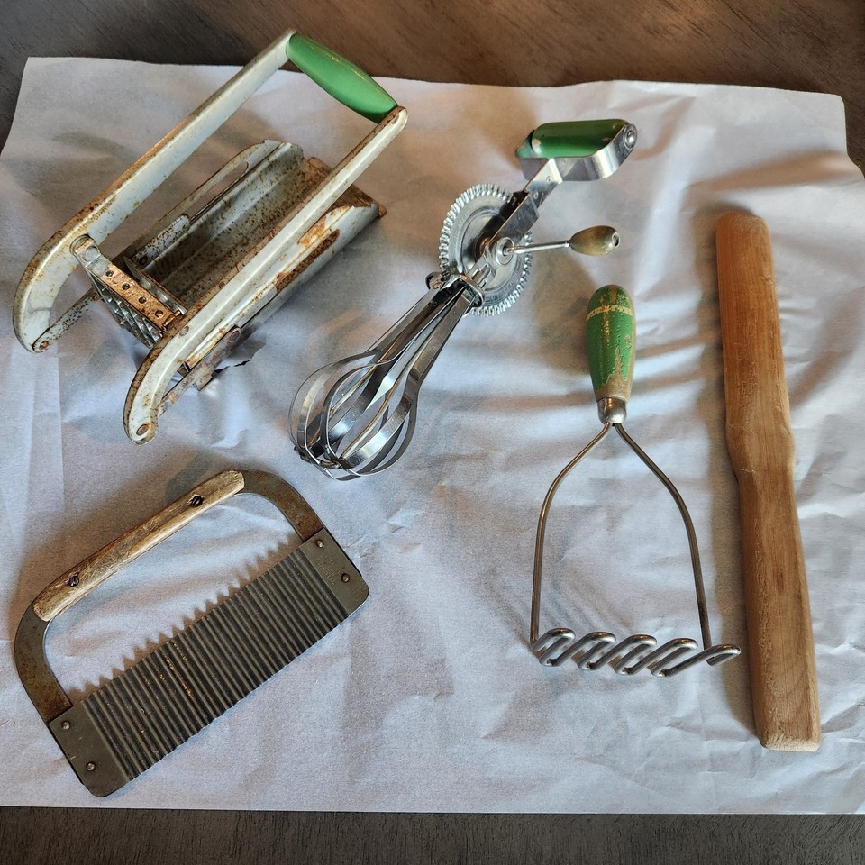 A curated bundle of genuine farmhouse-era kitchen tools with wooden handles — the kind of tactile, characterful pieces that make a kitchen feel lived-in and storied.