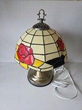 Tiffany-style lamp with a red rose stained shade and antique brass finish base.