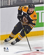 Matt Grzelcyk Boston Bruins Unsigned Skating with Puck vs Hurricanes Photo