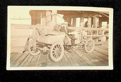 Snapshot Two Gentlemen in Caps Sitting in Very Old Car on a Pier, early 1900s