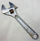 Silver 6-inch adjustable crescent wrench with worn handle, yellow “706,” and black text “Made in U.S.A.”