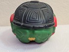 Black and green Teenage Mutant Ninja Turtles football Raphael with textured silver helmet and red tail.