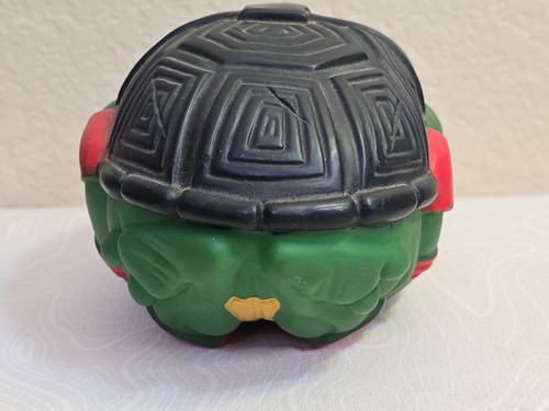 Black and green Teenage Mutant Ninja Turtles football Raphael with textured silver helmet and red tail.