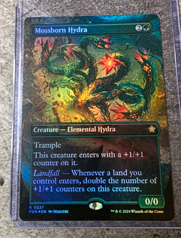 Mossborn Hydra - Foil Rare #337 - Foundations - borderless 