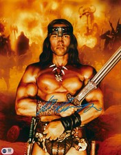 ARNOLD SCHWARZENEGGER SIGNED CONAN 14x11 PHOTO (ACG CERT AG16623)