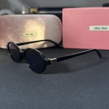Miu Miu Women's Oval Sunglasses Black Frame Black Lenses with Gold Accents