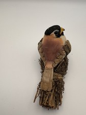 Handmade hand carved wooden bird on nest