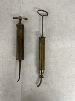 (2) Vintage Brass Oil Injector Pump Champion And 1 Other
