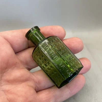 SUPERB TINY GREEN GLASS COFFIN SHAPED POISON BOTTLE EMBOSSED NOT TO BE TAKEN - Image 1 of 4