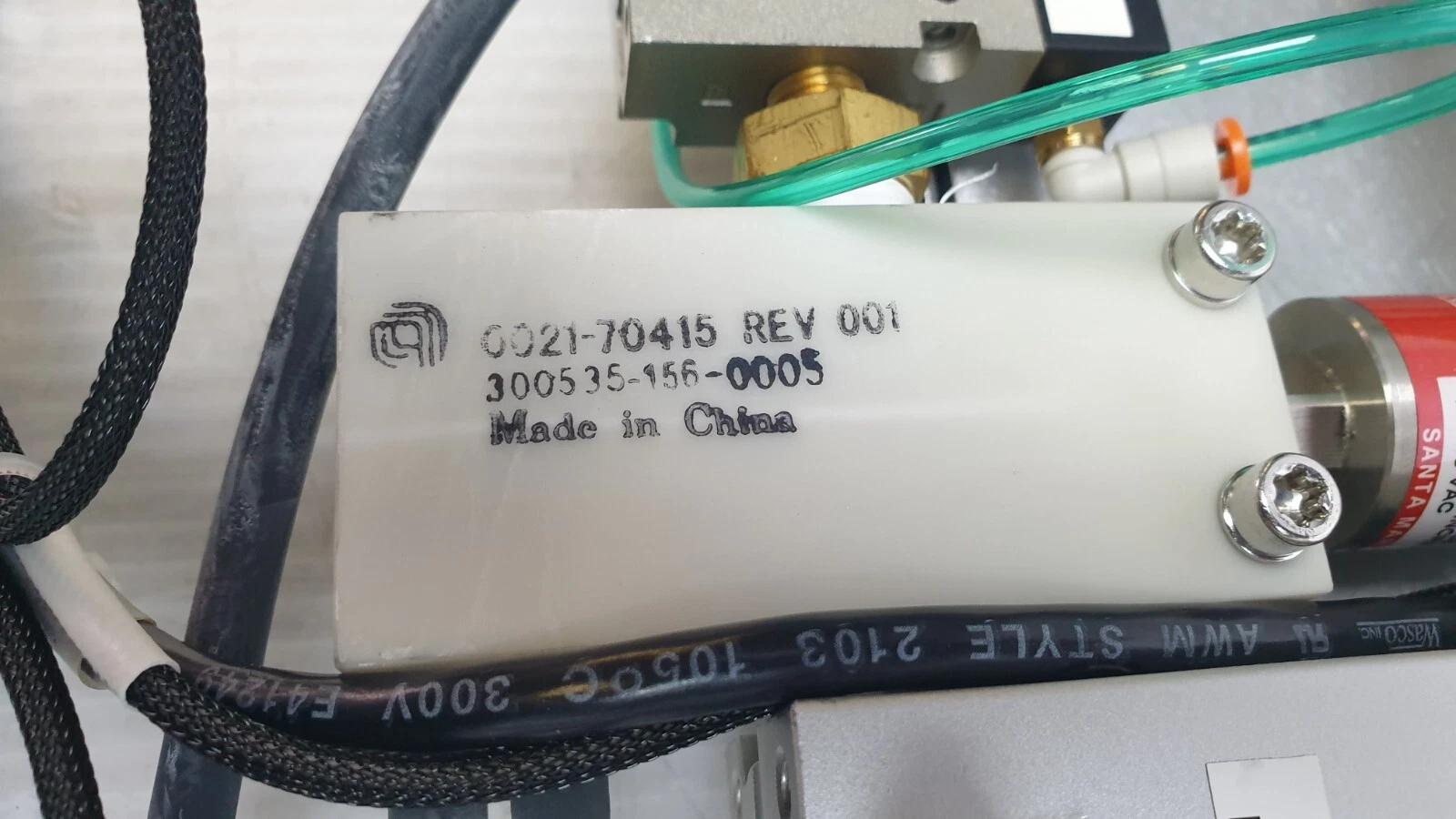White block marked 0021-70415 REV 001, 300535-156-0005