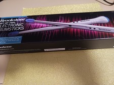 BRAND NEW BROOKSTONE SET OF TWO ELECTRONIC DRUMSTICKS.