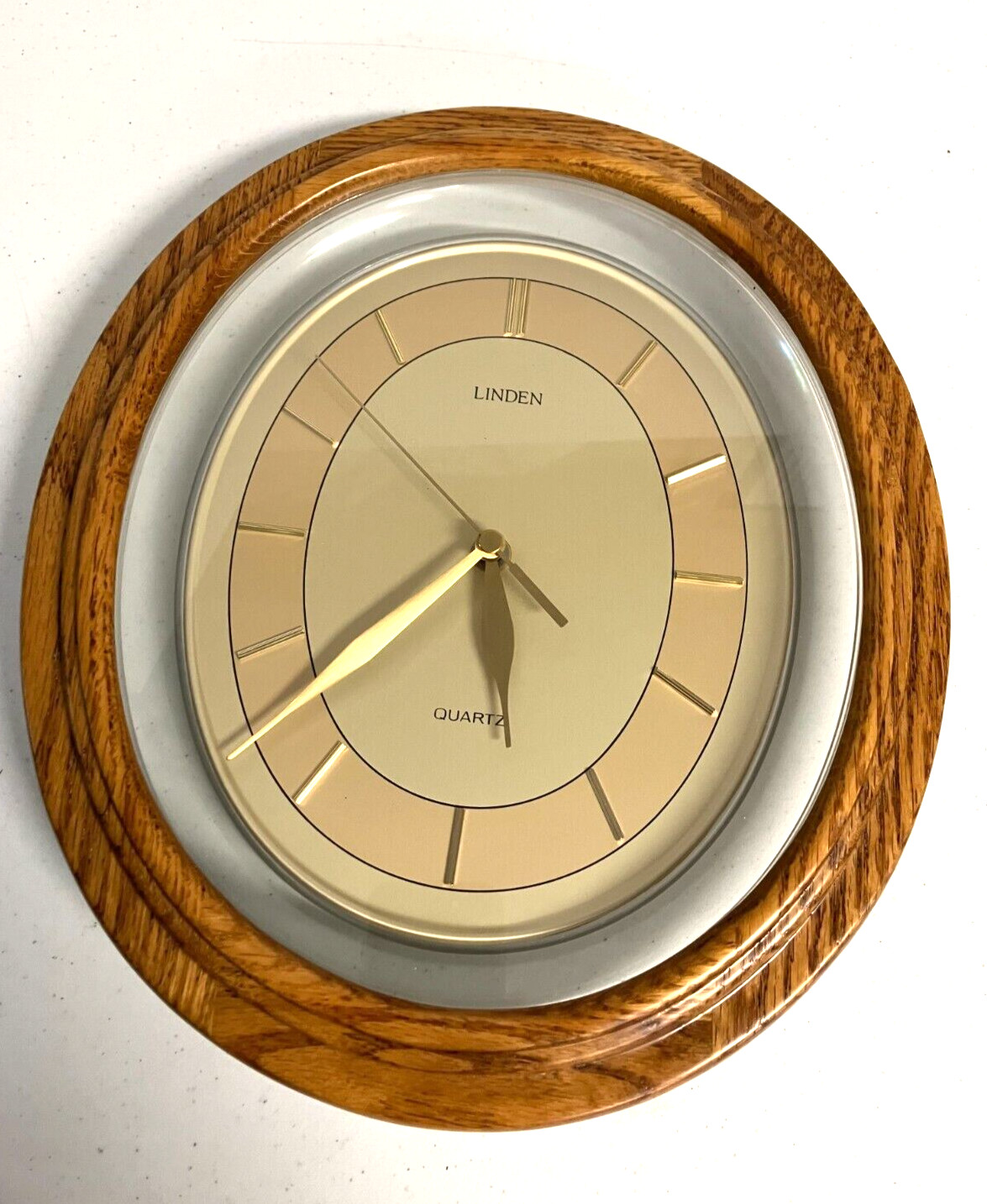 Beautiful Linden Quartz Oval Wall Clock, 12.5" x 11" Keeps time well, wood/glass