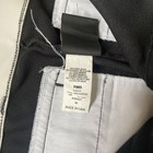 Black Wilson RMB A4409 men’s baseball pants with blue and white vertical stripes, made in USA, on inner collar tag.