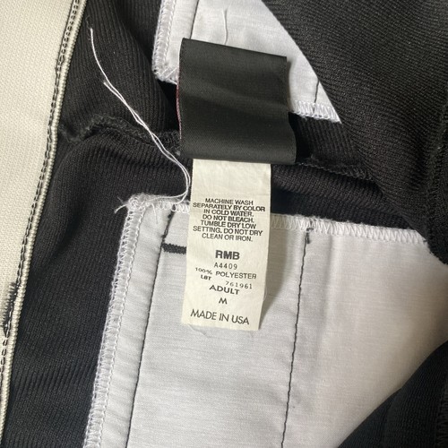 Black Wilson RMB A4409 men’s baseball pants with blue and white vertical stripes, made in USA, on inner collar tag.