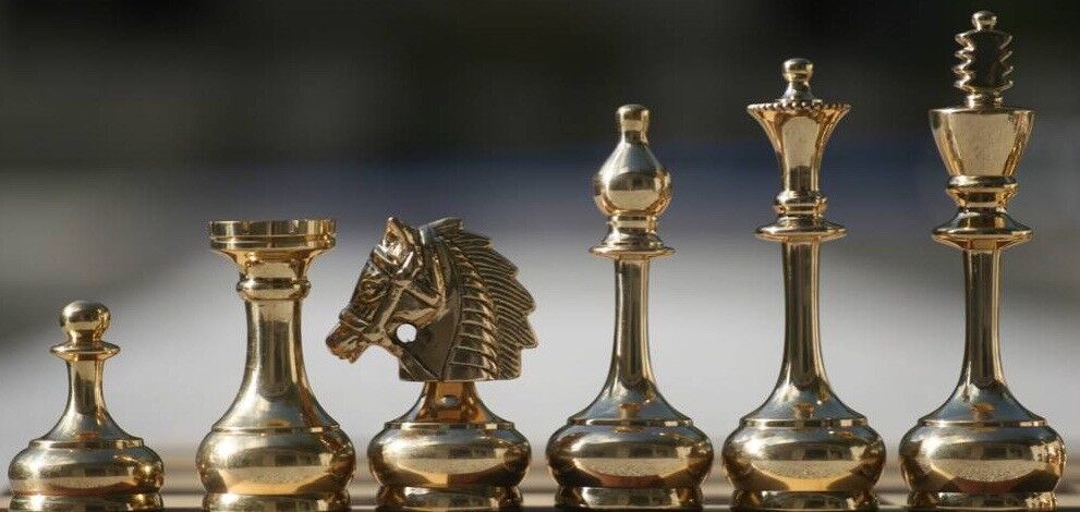 Gold Chess Pieces on Black Surface · Free Stock Photo